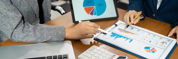 Businessman team hand Project manager working and update tasks and Gantt chart scheduling virtual diagram.with laptop in office.