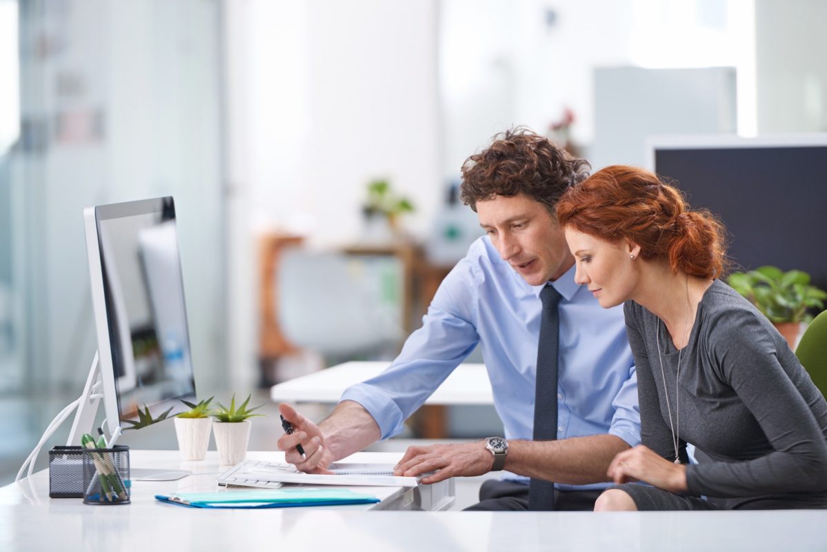 Young business professionals discussing work documents